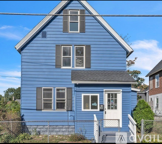 A blue house with a white door and windows.