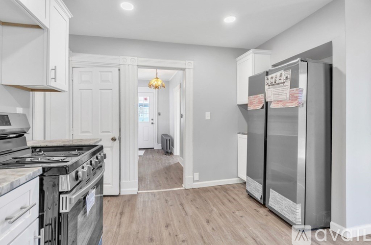 A kitchen with a stove top oven and a refrigerator.