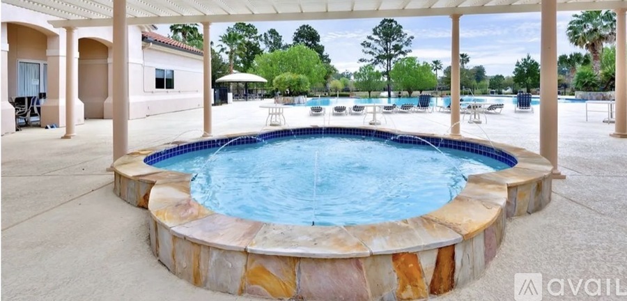 A hot tub sits in the middle of a patio.