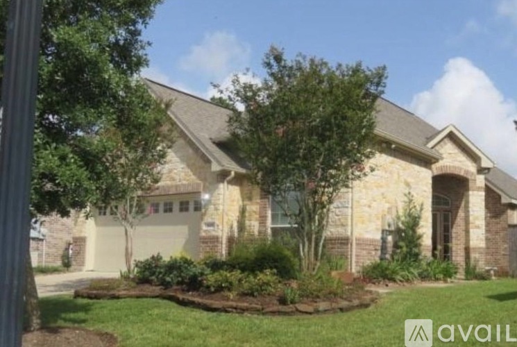 A house with a well-maintained lawn and landscaping in front.