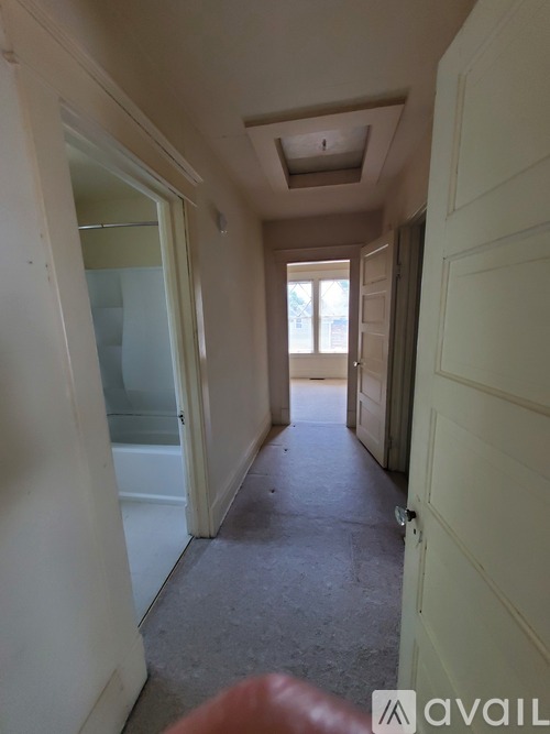A long hallway with doors on both sides.