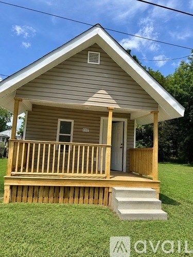 A small house with a porch and a door.
