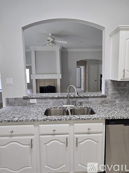 A kitchen with a sink and cabinets.