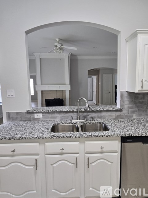 A kitchen with a sink and cabinets.