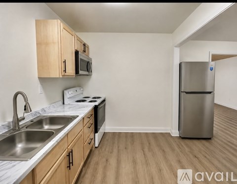 A kitchen with wooden cabinets and stainless steel appliances.