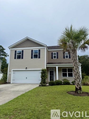 A house with a palm tree in front.