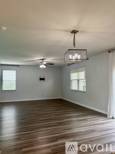 A room with wooden floors and a ceiling fan.