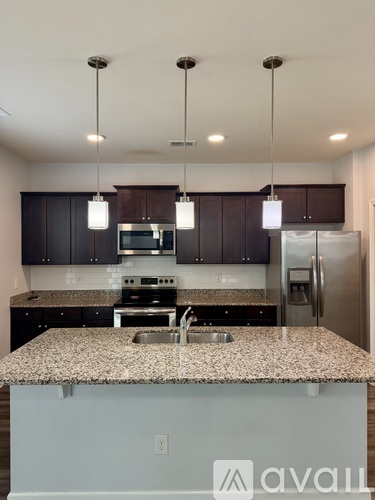 A kitchen with granite countertops and stainless steel appliances.