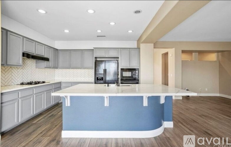 A kitchen with a blue island in the middle.
