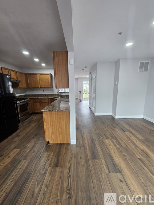 A kitchen with wooden floors and a countertop.