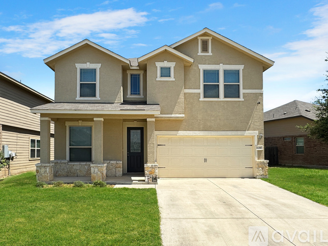 A two-story house with a garage is shown in the image.