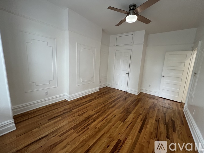 A room with wooden floors and white walls.