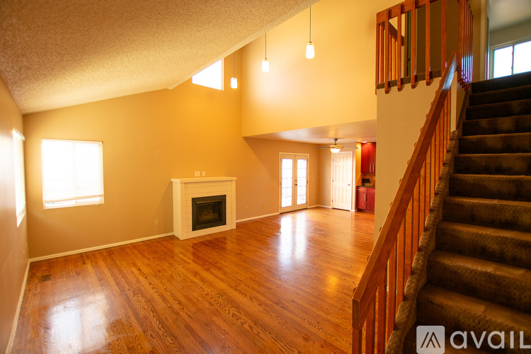 A living room with a staircase leading to the upper floor.
