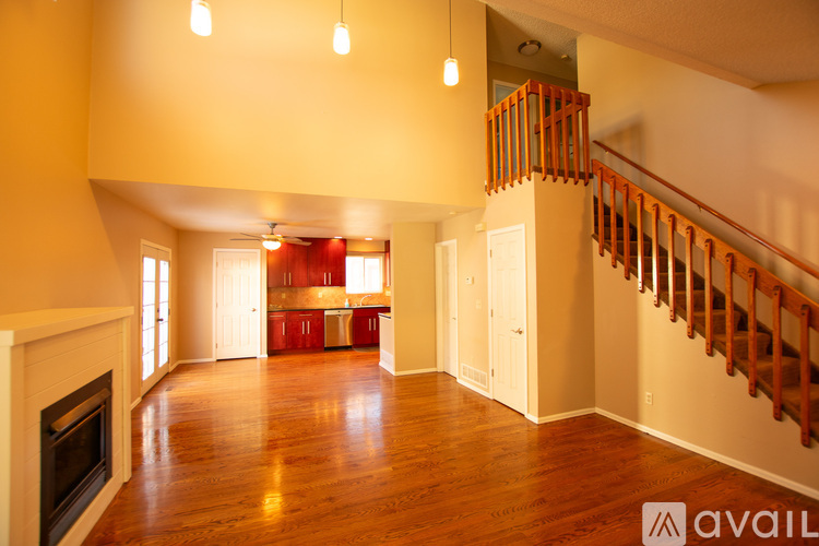 A large open living room with a fireplace and a staircase.