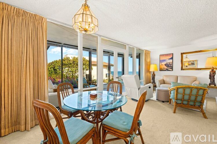 A dining room with a glass table and chairs.