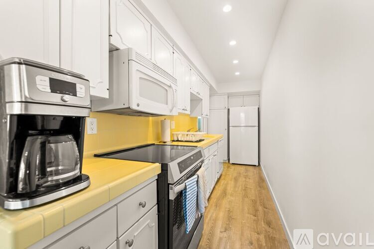A kitchen with a coffee maker on the counter.