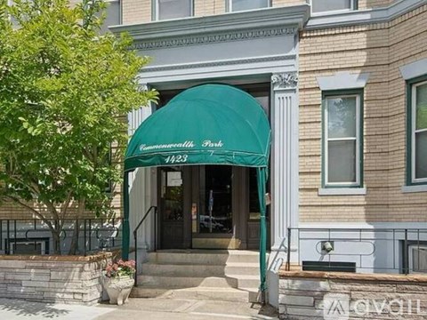 A building with a green awning that says "Commonwealth Park".