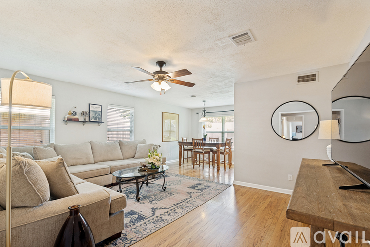 A living room with a couch, a coffee table, and a television.