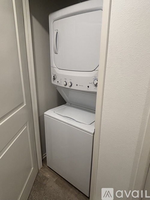 A white washing machine and dryer in a small laundry room.