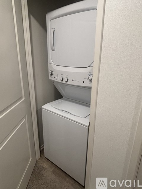 A white washing machine and dryer in a small laundry room.