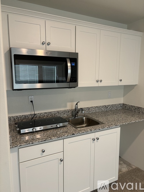 A kitchen with a microwave above the sink.