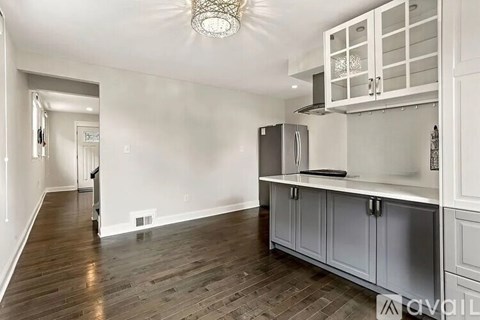 A kitchen with a refrigerator and cabinets.