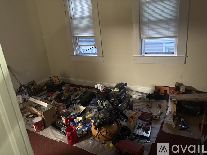 A messy room with a lot of clutter on the floor.