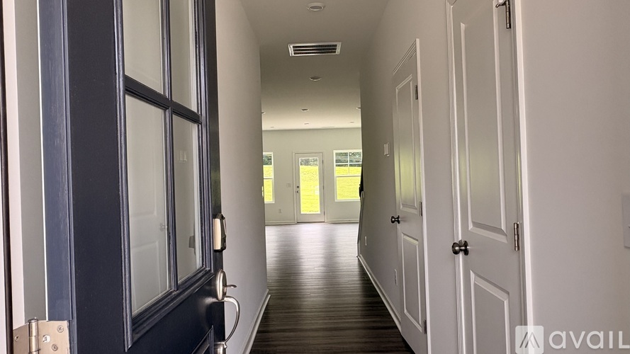 A long hallway with doors on both sides.