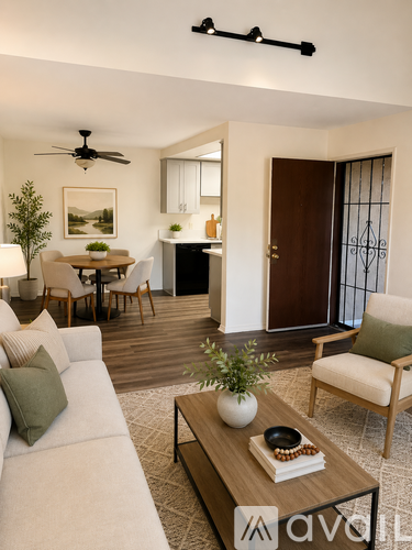 A living room with a white couch, a wooden coffee table, and a ceiling fan.
