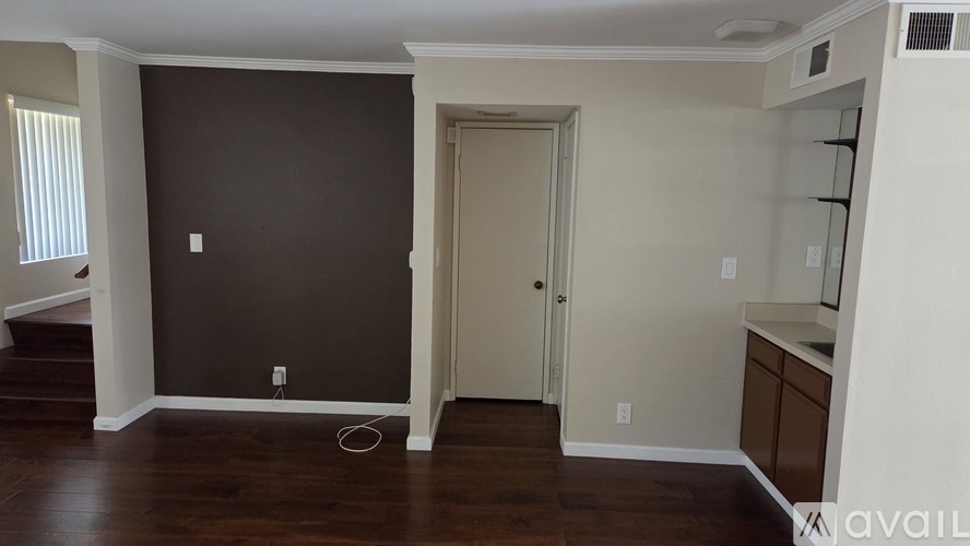 A room with a brown wall and a white door.