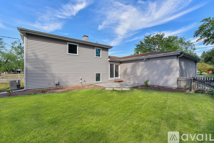 A house with a well-maintained lawn is for sale.