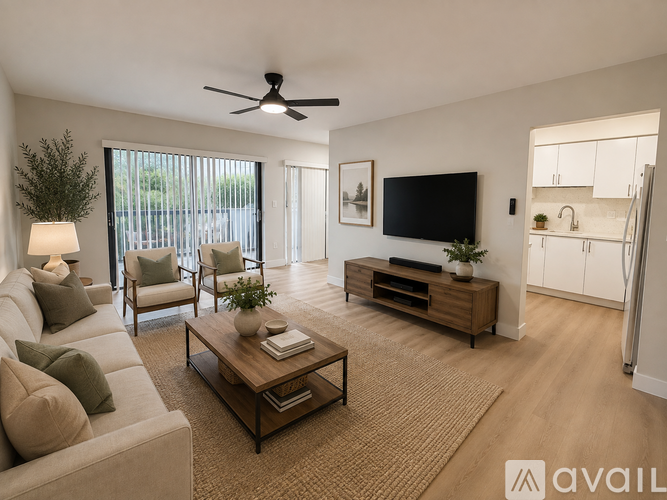 A living room with a beige sofa, a wooden coffee table, and a flat-screen TV mounted on the wall.