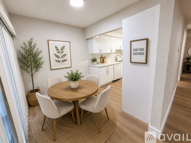 A dining room with a round table and chairs.