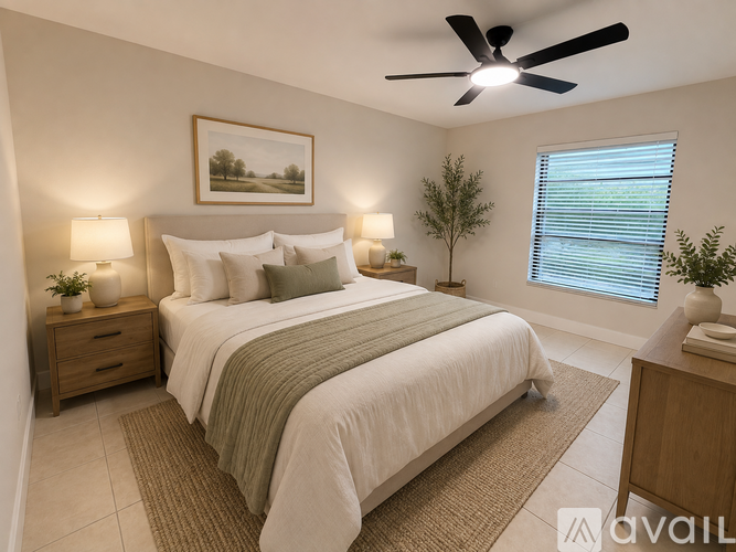 A bedroom with a large bed, a ceiling fan, and a painting on the wall.