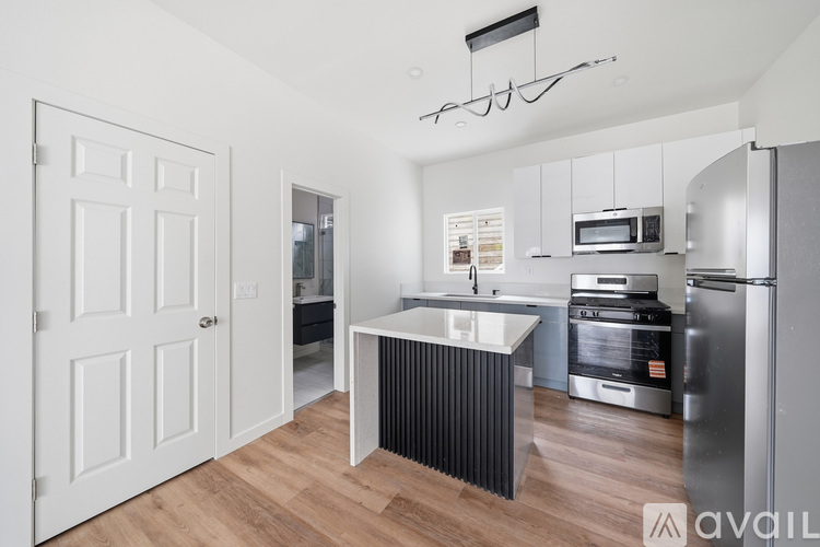 A kitchen with a white door and a white fridge.
