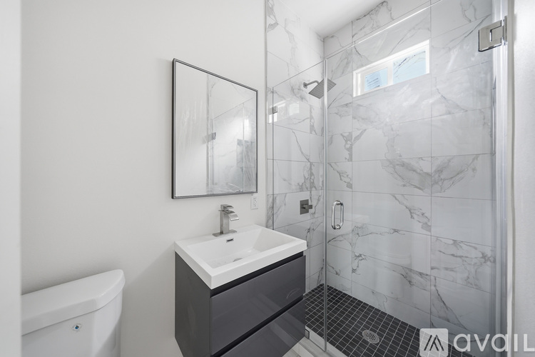 A bathroom with a white sink and a white bathtub.