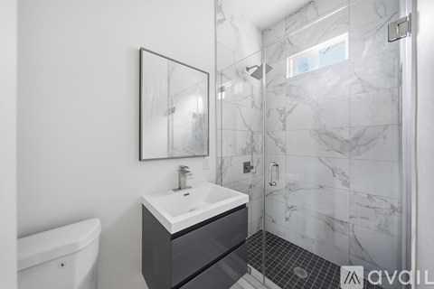 A bathroom with a white sink and a white bathtub.