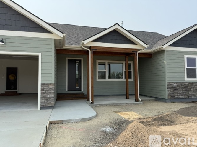 A house with a grey exterior and a brown roof.