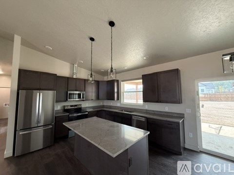 A modern kitchen with a large island in the center.