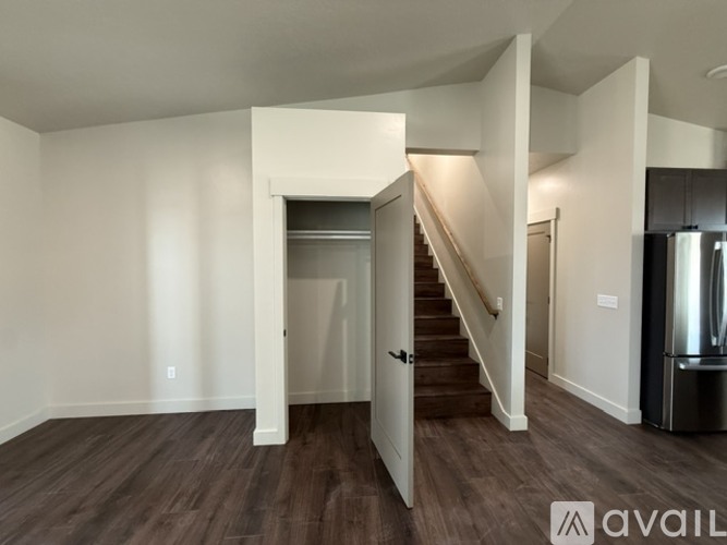 A spacious room with a staircase leading to another level.