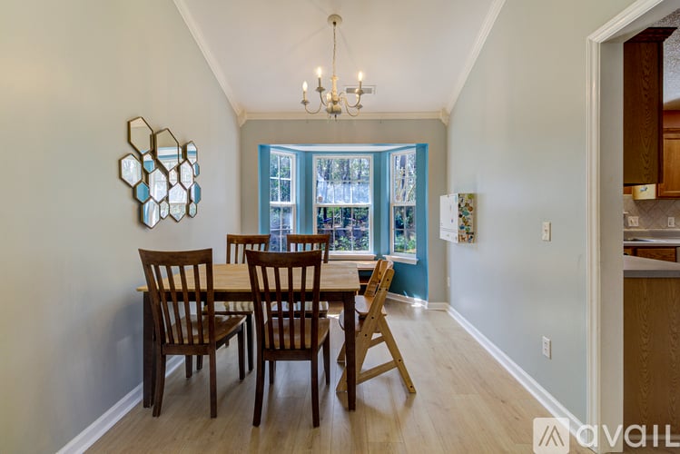A dining room with a table set for four.