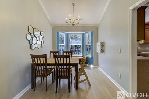 A dining room with a table set for four.