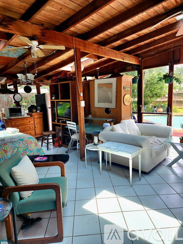 A living room with a white couch and a green chair.