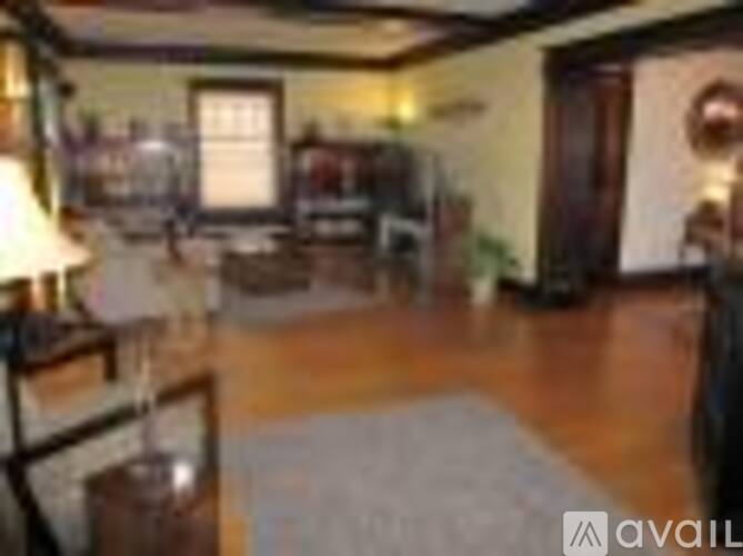 A living room with a couch and a lamp.