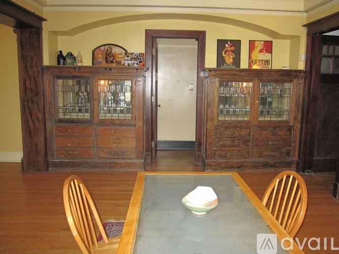 A dining room with a glass table and chairs.
