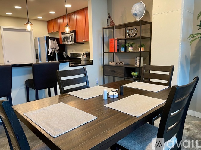 A kitchen with a dining table set for four.