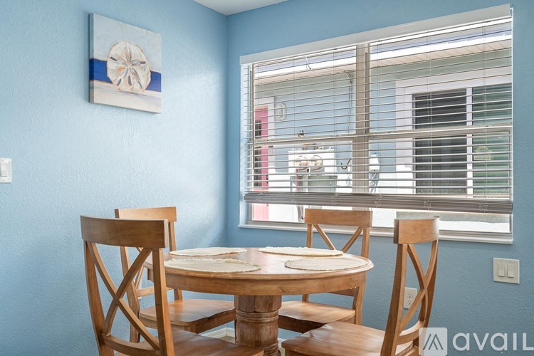 A dining room with a table and chairs.