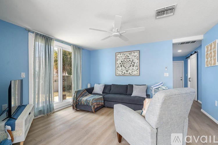 A living room with a grey couch and a television.