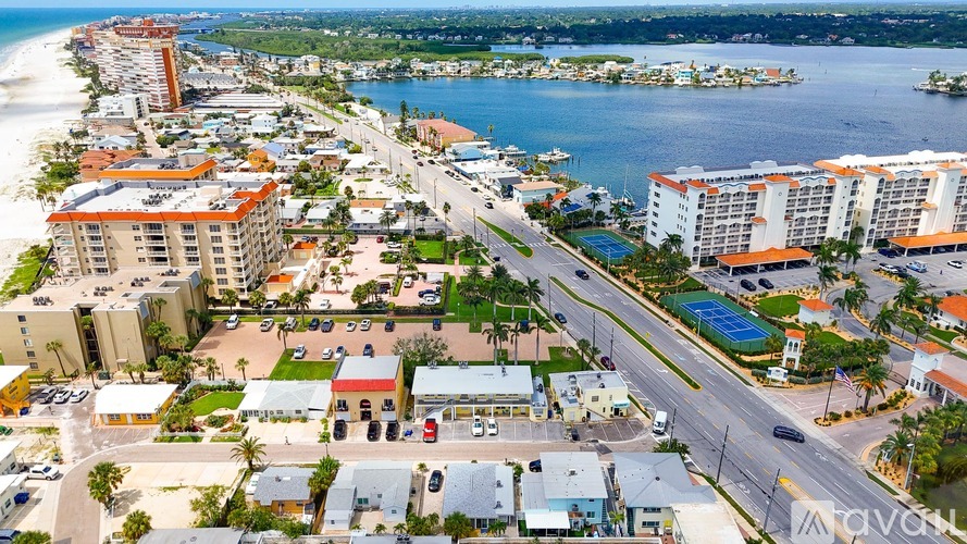A beachfront city with apartment buildings and a pool.