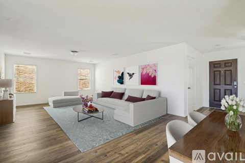 A living room with a white couch and a coffee table.